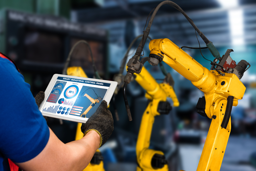 Industrial robotic arm operating on an automated production line in a factory setting.