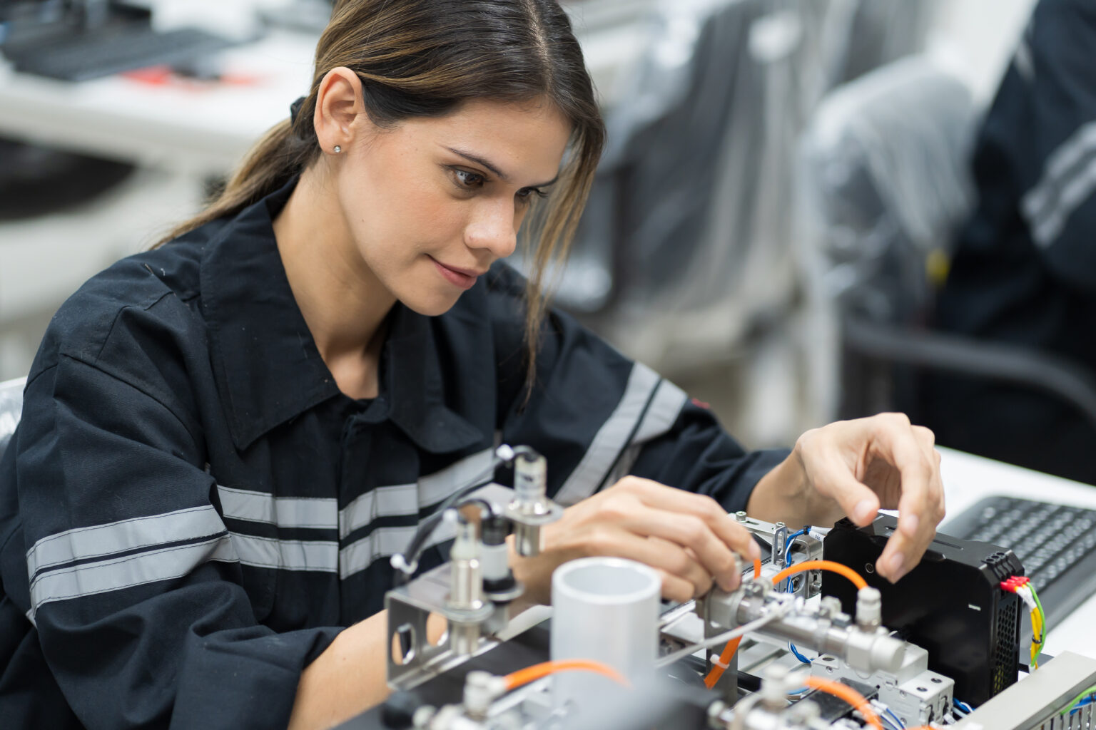 Female engineer training AI robot training kit and mechatronics engineering in the manufacturing automation and robotics academy room