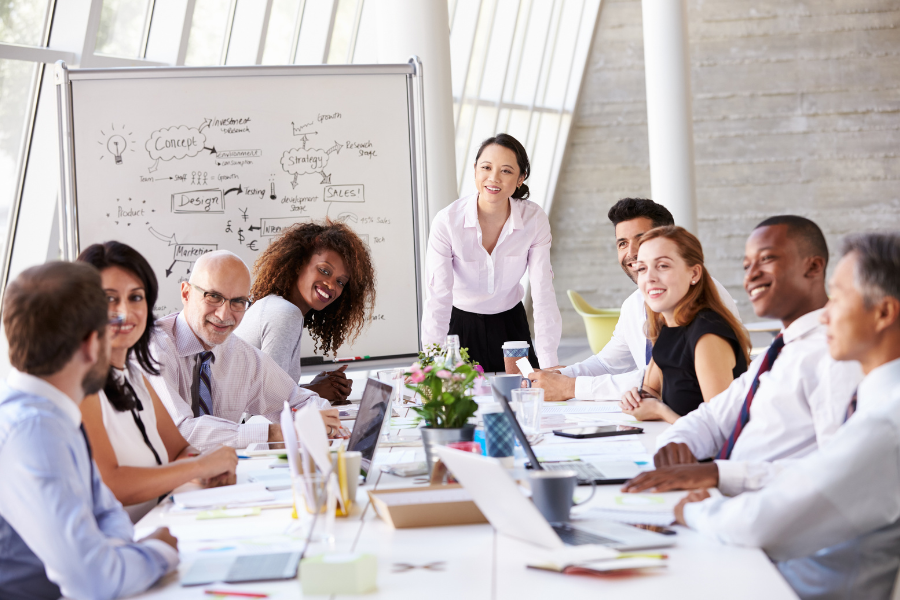 a group of people sitting around a table in an office