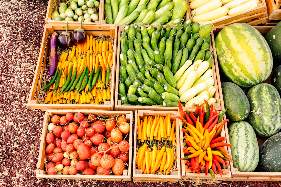 many different types of vegetables are displayed in wooden crates