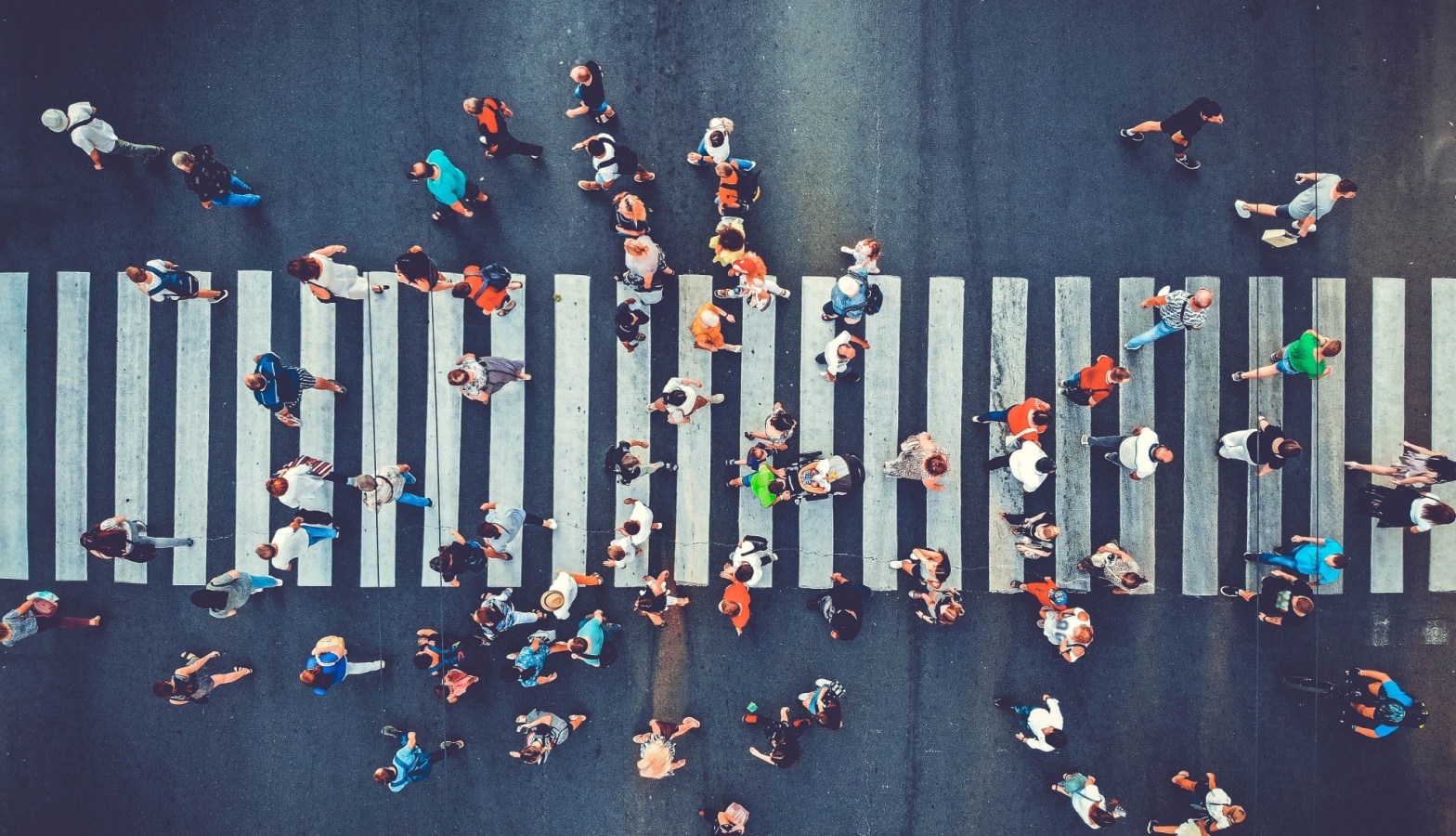 an aerial view of people crossing a street