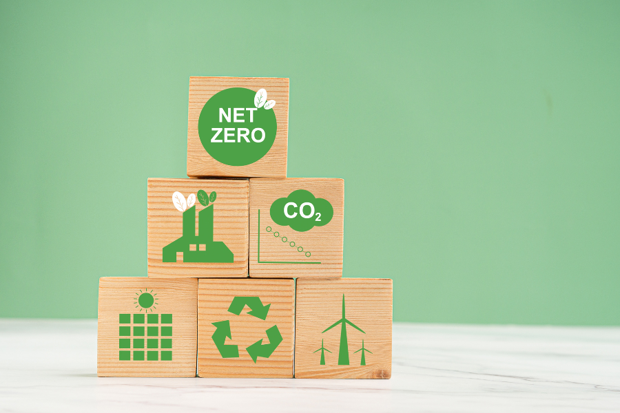 a stack of wooden blocks with the words net zero on them