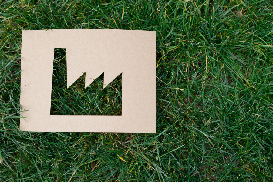 paper cutout of factory in the grass